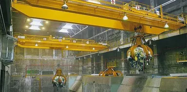 Overhead grab crane discharging coal into a power station hopper