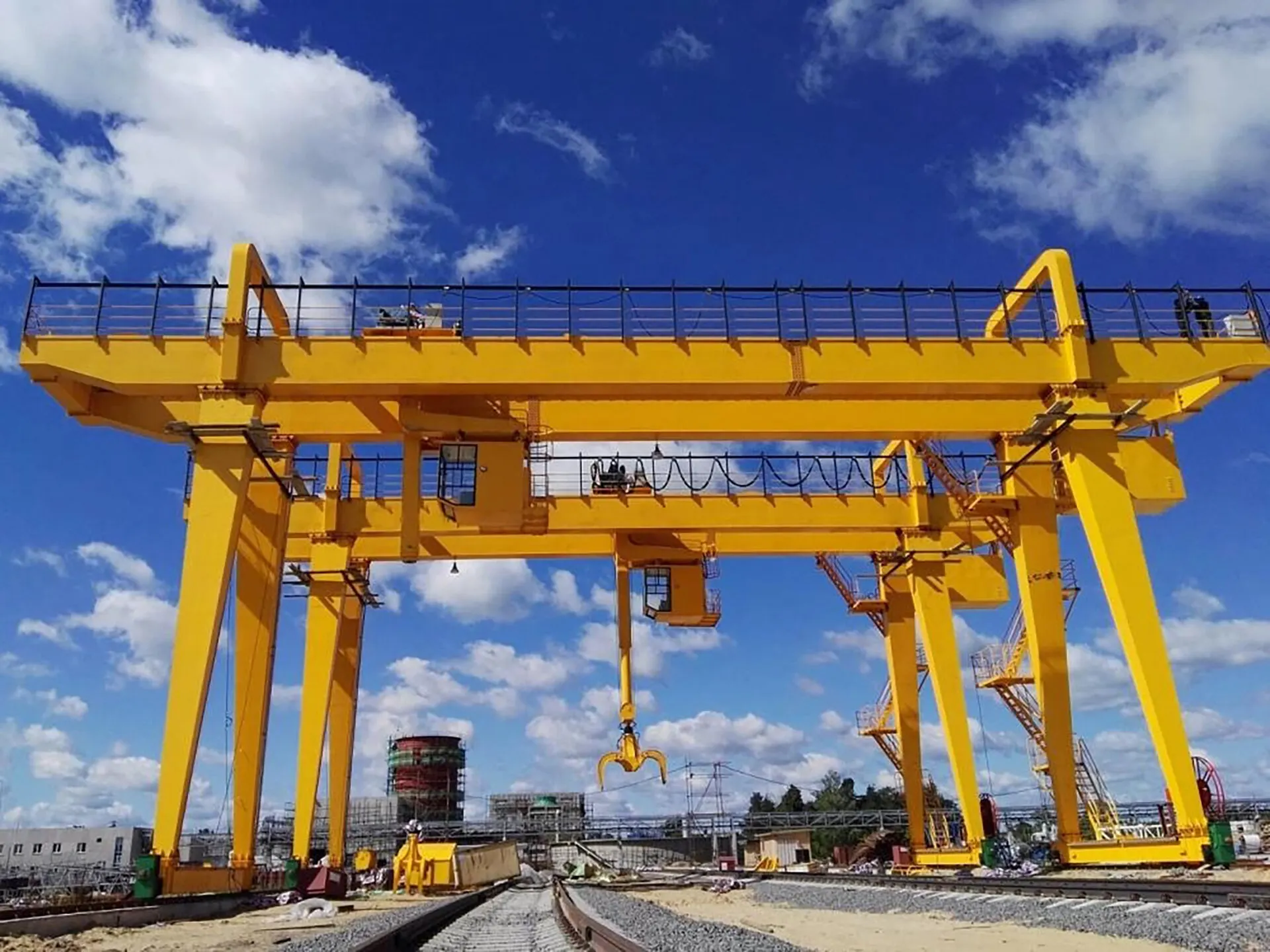 Heavy-duty double girder gantry crane working an outdoor fabrication yard