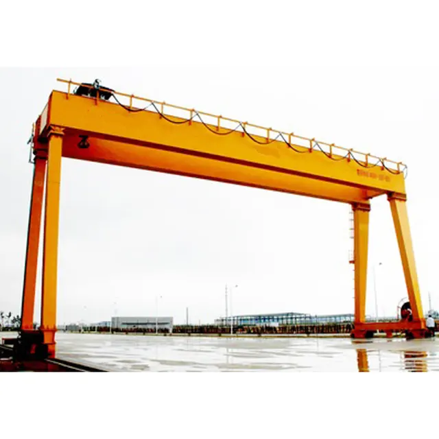 Double girder gantry crane running on ground rails outside a workshop