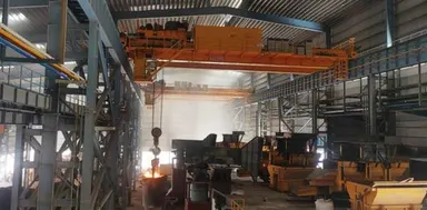 Ladle crane handling molten metal above the casting bay of a steel plant