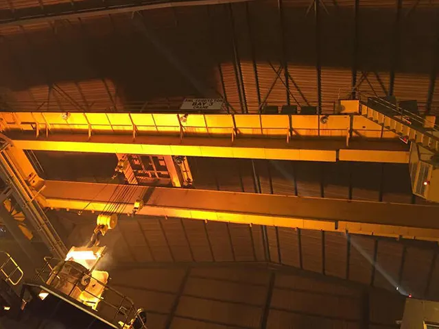 Double girder overhead crane spanning the hot bay of a steel rolling mill